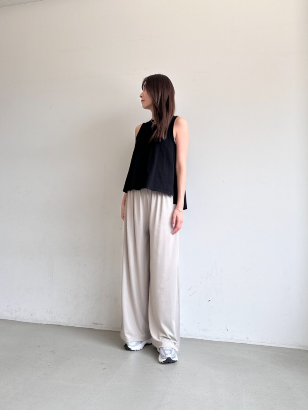 ブラック系のタンクトップ、ベージュ系のその他パンツを着用したレディースの夏コーディネートの2枚目の写真