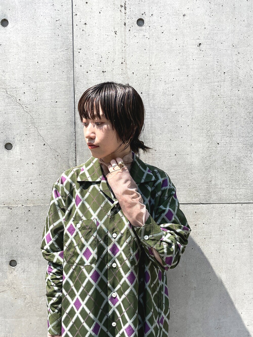 ベージュ系のTシャツ/カットソー、グリーン系のシャツワンピース、ブラック系のブーツを着用したレディースの秋コーディネートの3枚目の写真