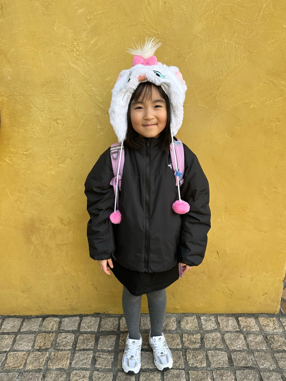 ブラック系のブルゾン、パープル系のバックパック/リュック、ブラック系のスカートを着用したキッズの冬コーディネートの5枚目の写真