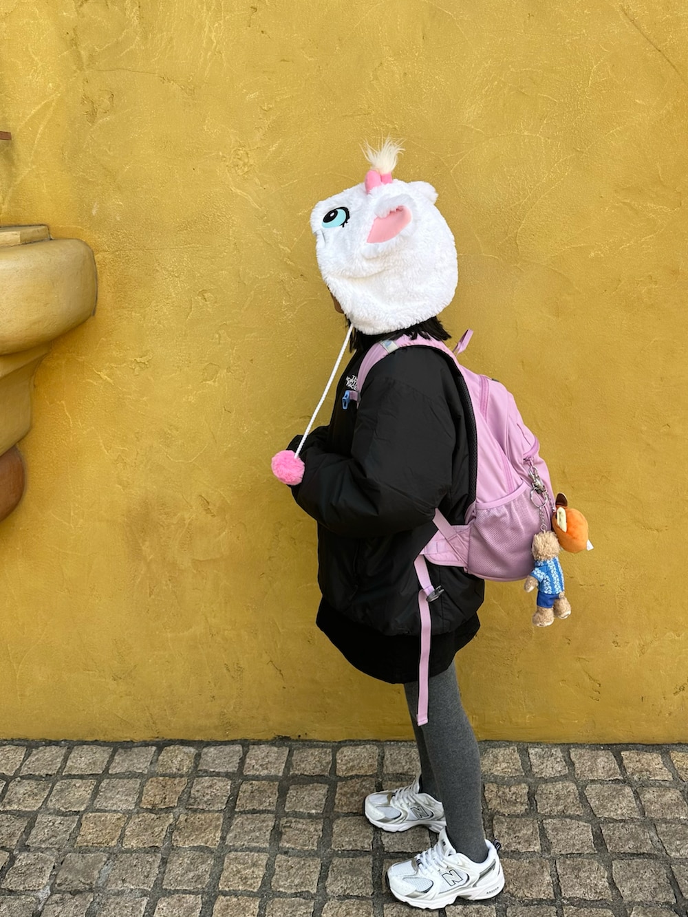 ブラック系のブルゾン、パープル系のバックパック/リュック、ブラック系のスカートを着用したキッズの冬コーディネートの2枚目の写真