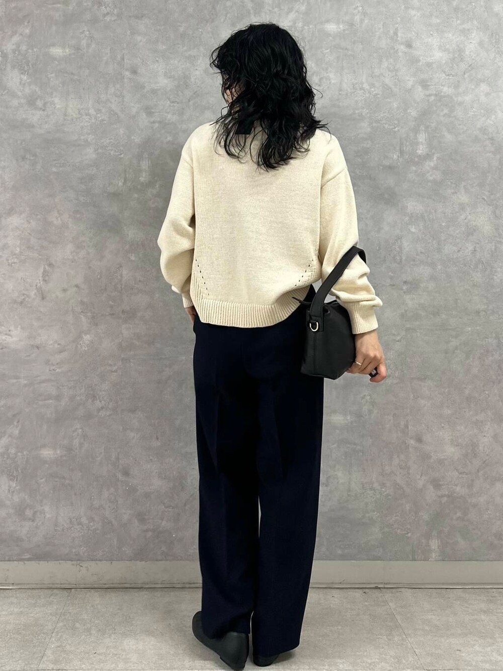 ブラック系のパンプス、ブルー系のその他パンツ、ホワイト系のニット/セーターを着用したレディースの春コーディネートの4枚目の写真