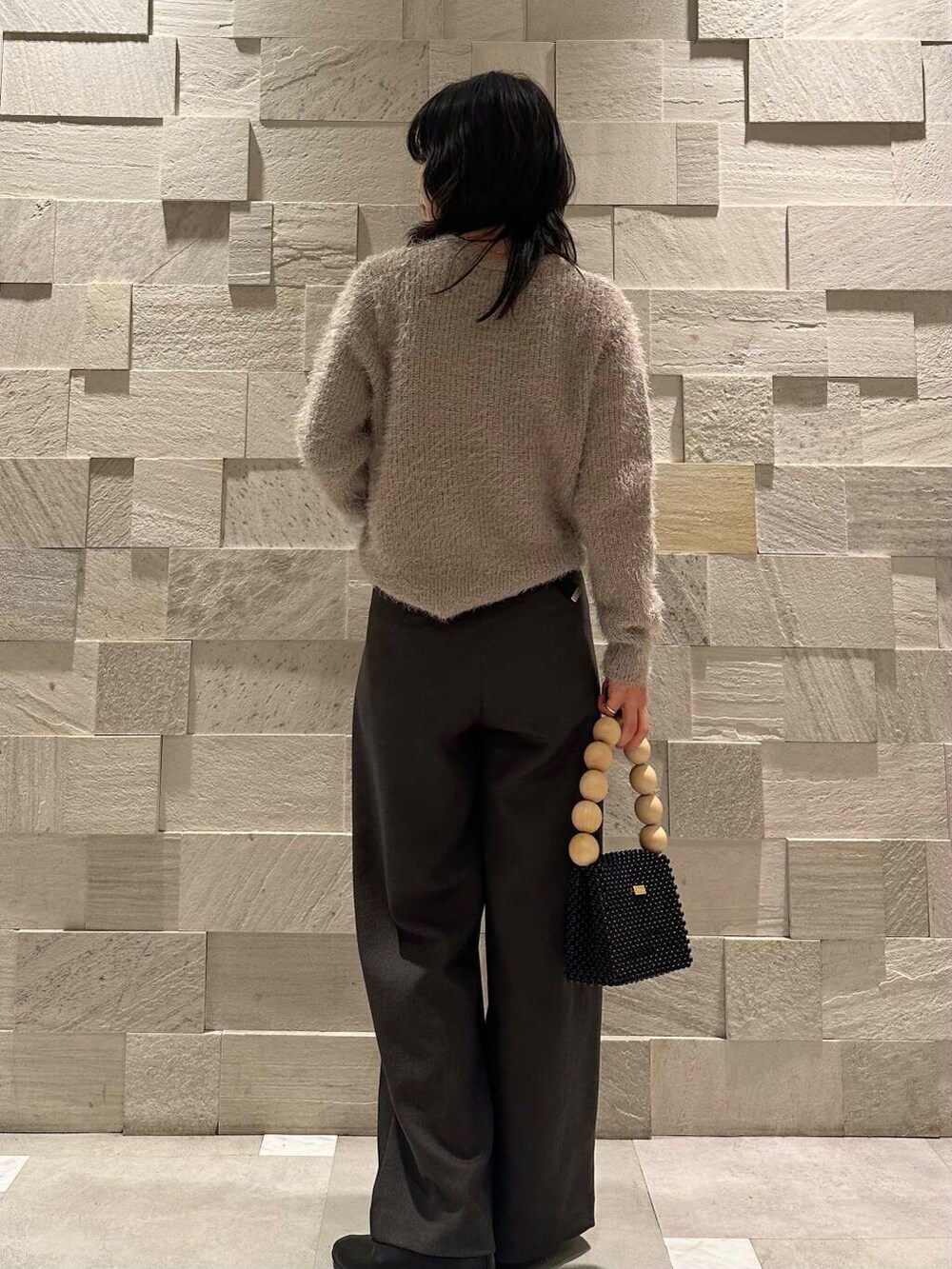 ホワイト系のダウンジャケット/コート、ブラック系のパンプス、グレー系のその他パンツを着用したレディースの冬コーディネートの3枚目の写真