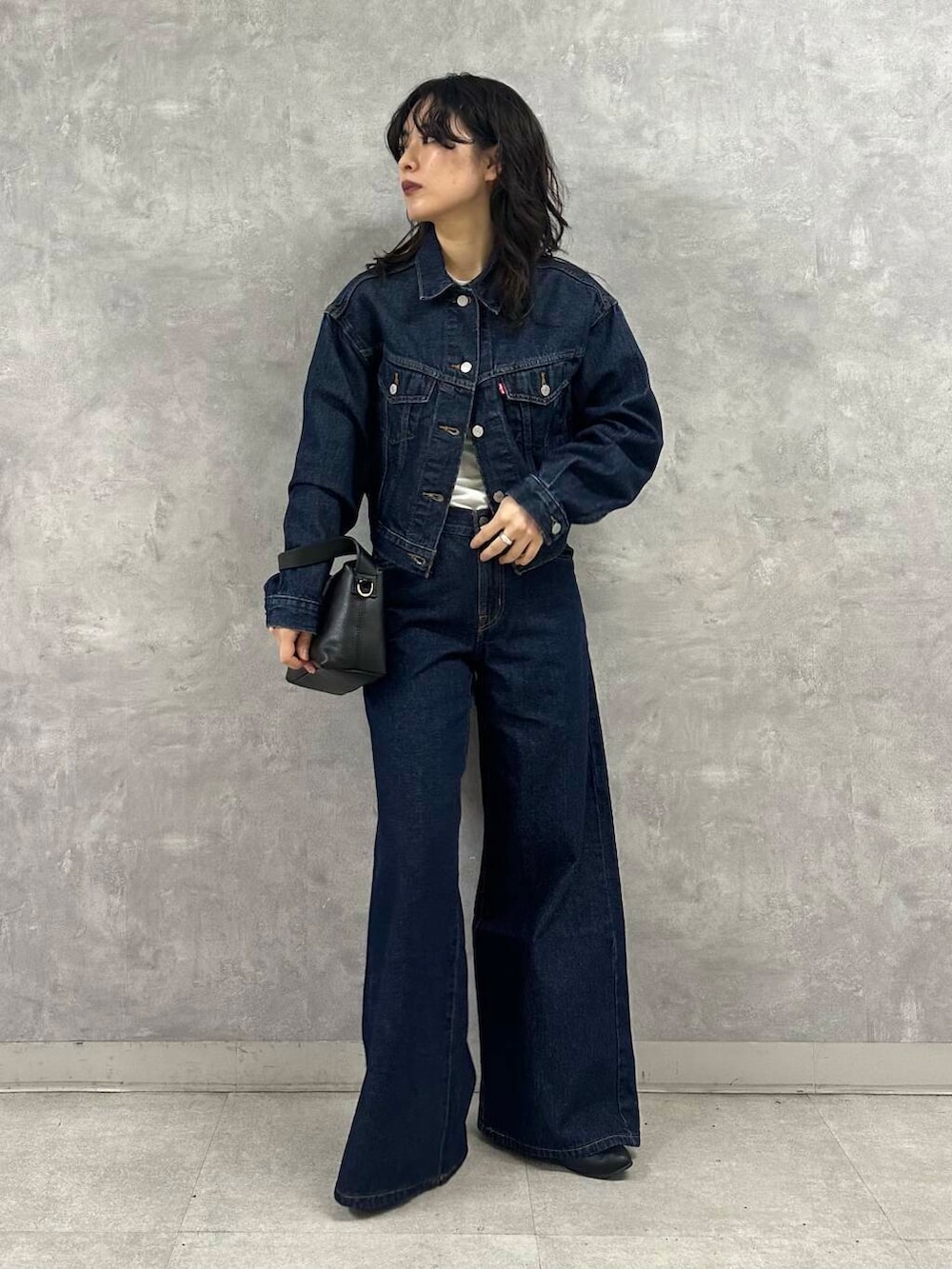 ブルー系のデニムジャケット、ホワイト系のTシャツ/カットソー、ベージュ系のその他アウターを着用したレディースの冬コーディネートの4枚目の写真