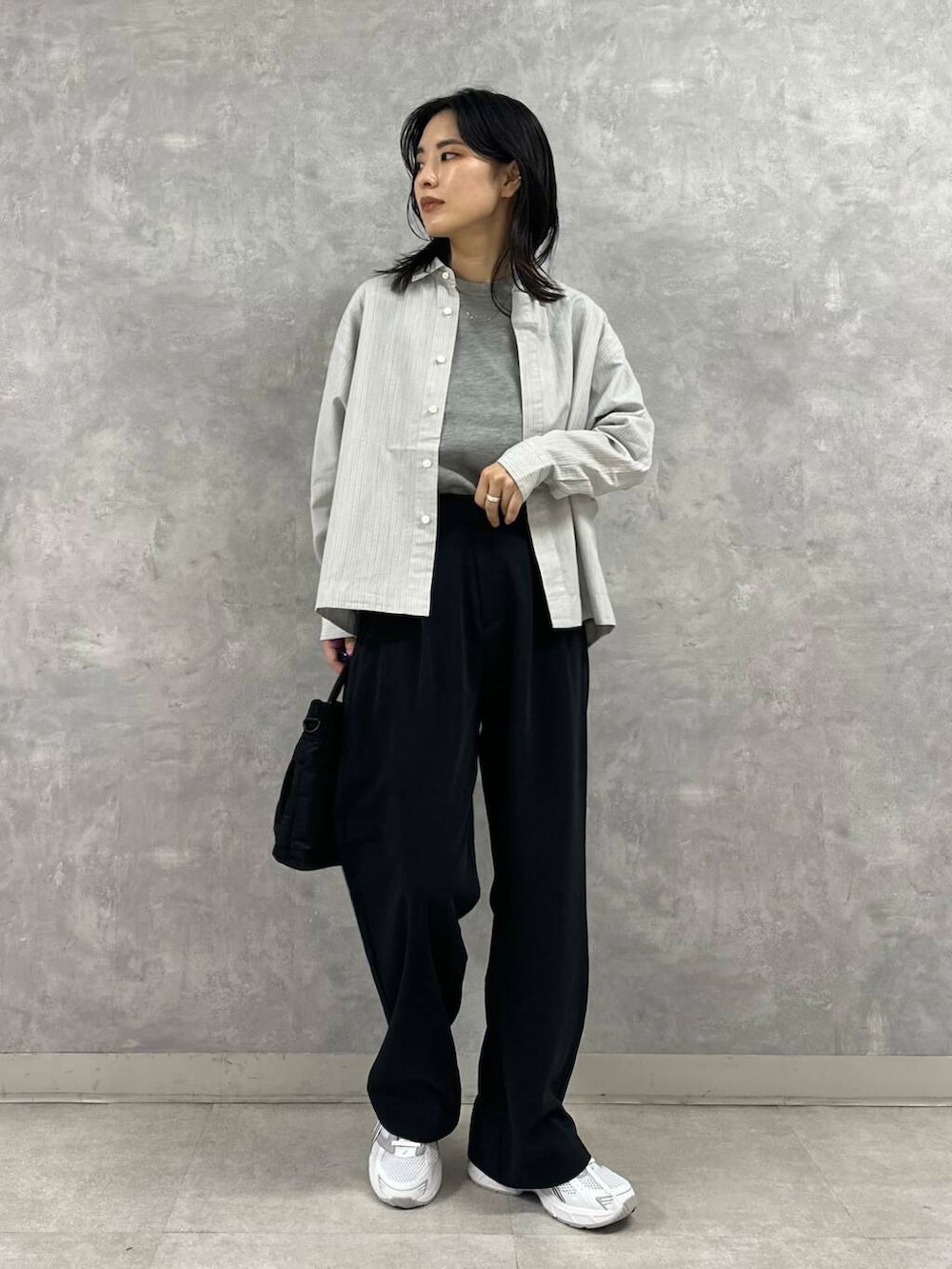 ブラック系のショルダーバッグ、グレー系のニット/セーター、ブラック系のその他パンツを着用したレディースの秋コーディネートの2枚目の写真