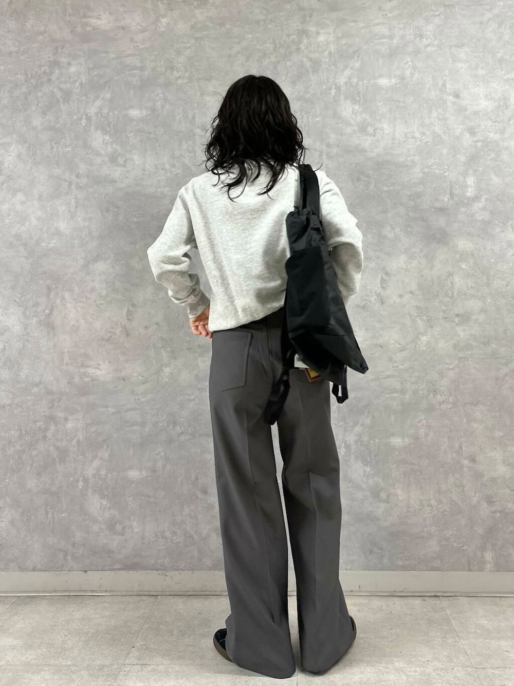 グレー系のその他パンツ、グレー系のTシャツ/カットソー、ブラック系のバックパック/リュックを着用したレディースの冬コーディネートの5枚目の写真