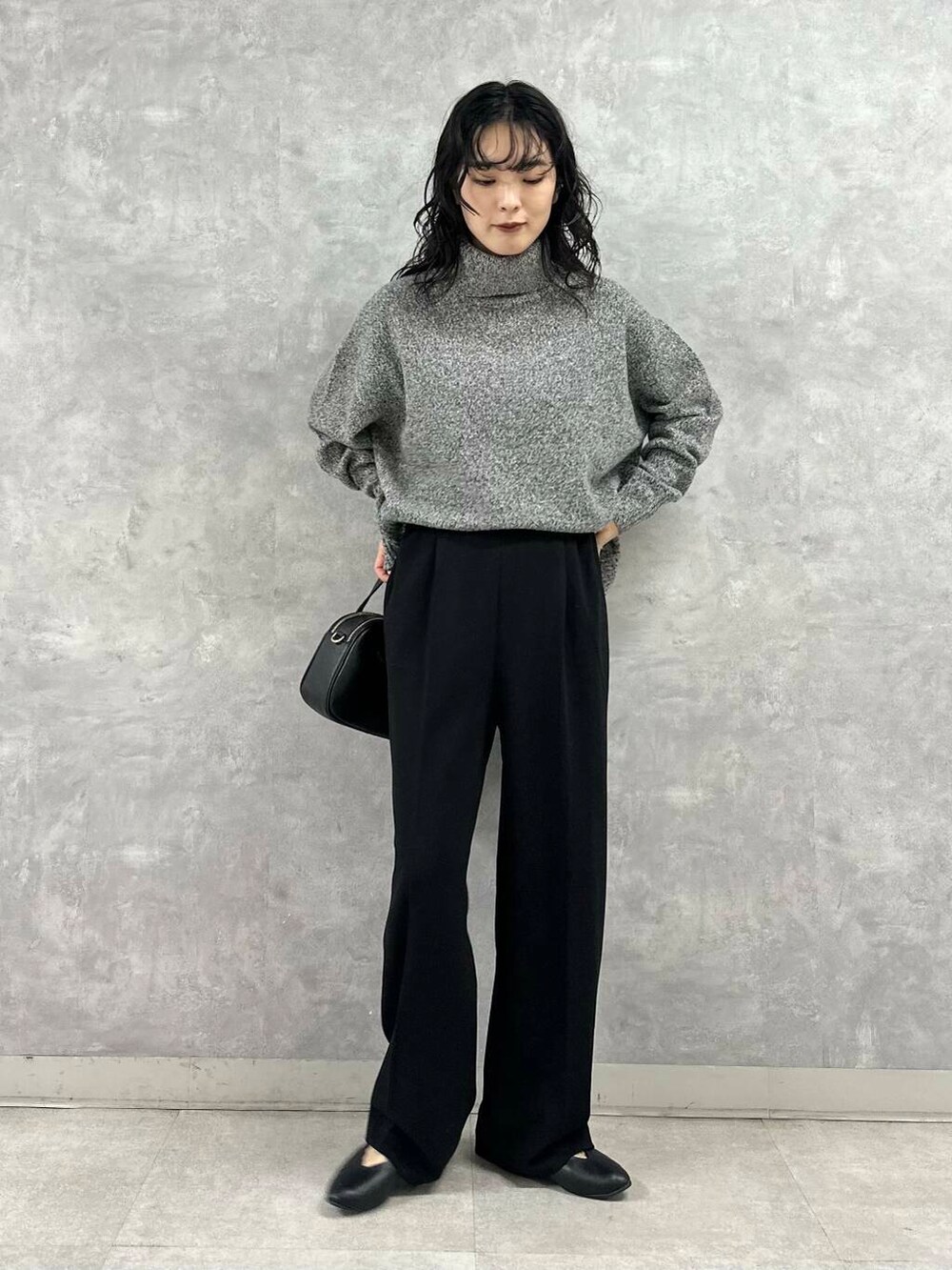 グレー系のその他アウター、ブラック系のニット/セーター、ブラック系のショルダーバッグを着用したレディースの冬コーディネートの6枚目の写真