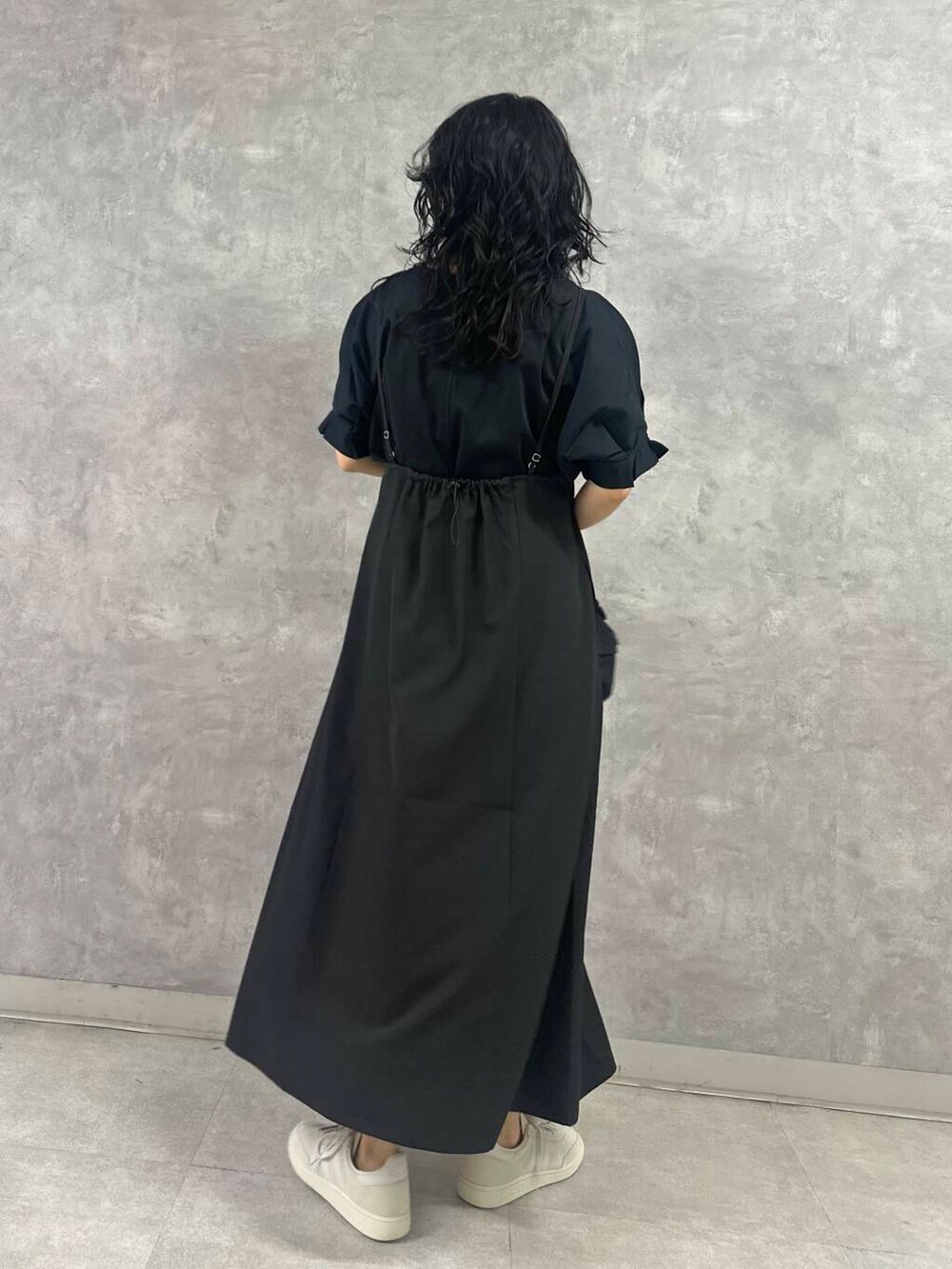 ブラック系のTシャツ/カットソー、ブラック系のワンピース、ホワイト系のスニーカーを着用したレディースの春コーディネートの4枚目の写真