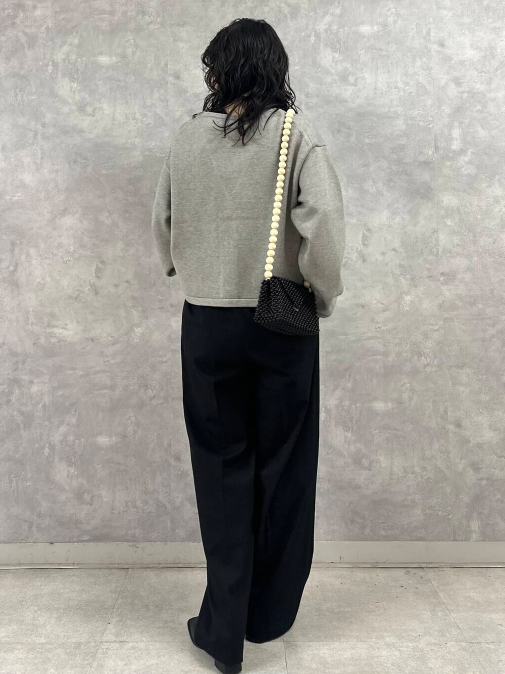 ブラック系のその他パンツ、グレー系のカーディガン/ボレロ、ブラック系のショルダーバッグを着用したレディースの冬コーディネートの5枚目の写真