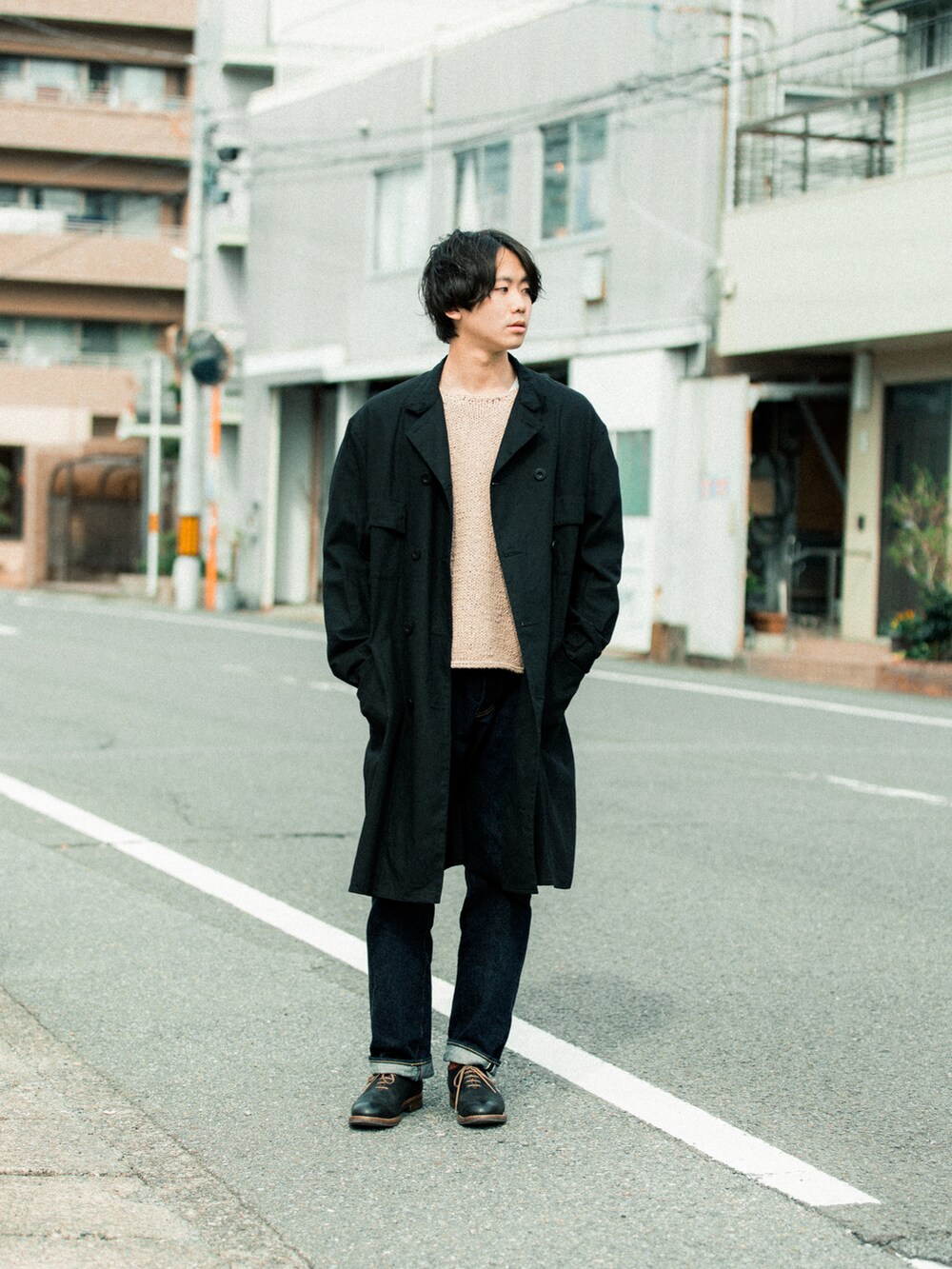 ブラック系のモッズコート、ブルー系のデニムパンツ、ブラック系のドレスシューズを着用したメンズの春コーディネートの2枚目の写真