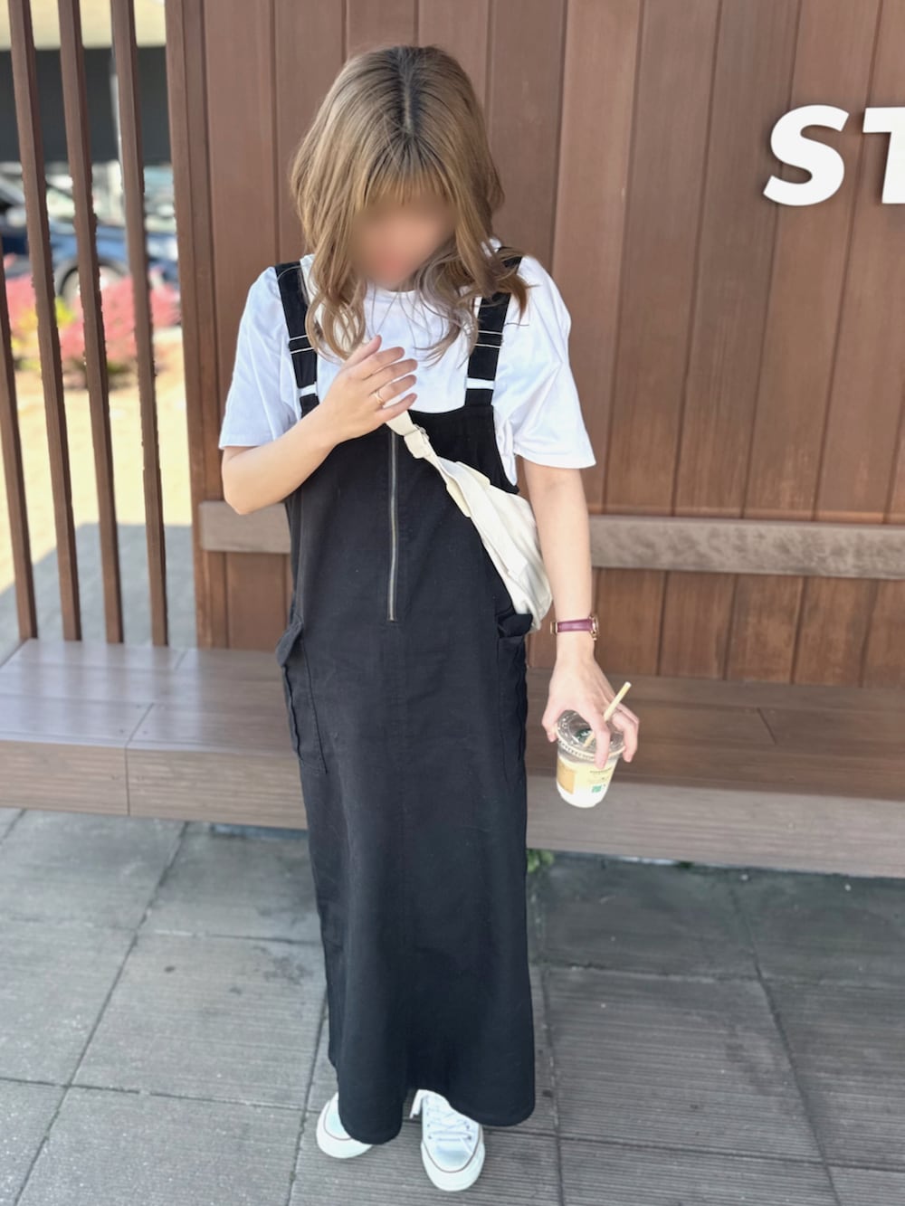 ホワイト系のTシャツ/カットソー、ブラック系のスカート、ホワイト系のスニーカーを着用したレディースの春コーディネートの2枚目の写真