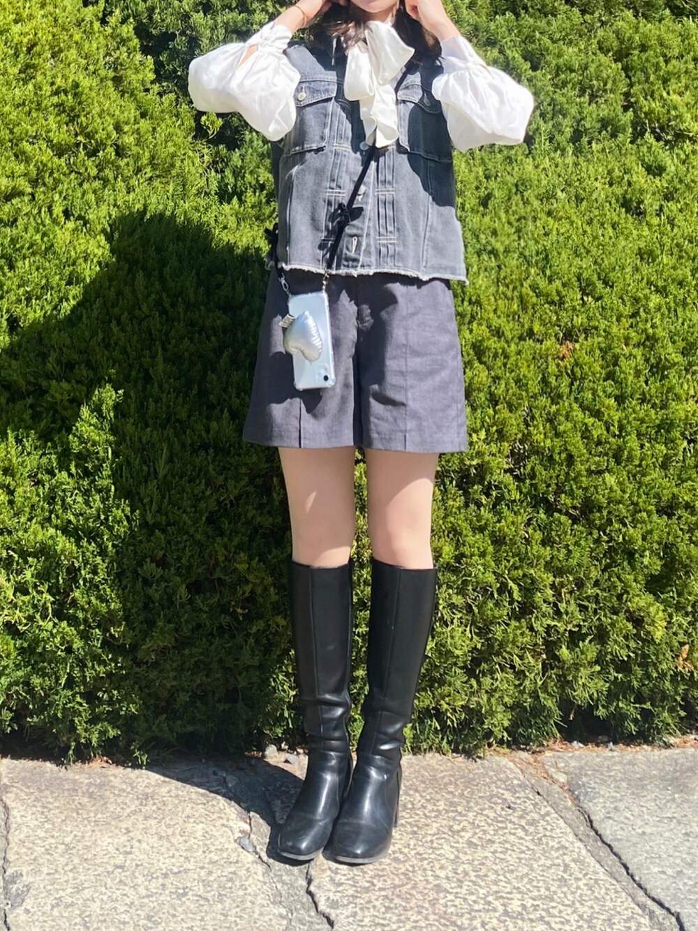 ホワイト系のシャツ/ブラウス、グレー系のベスト、ブルー系のパンツを着用したレディースの夏コーディネートの2枚目の写真