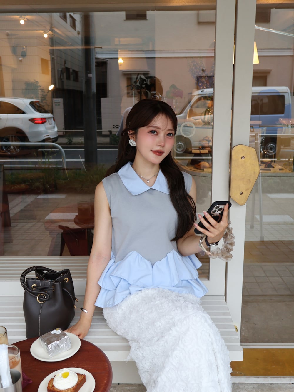 グレー系のシャツ/ブラウス、ブラック系のスカート、ブラウン系のサンダルを着用したレディースの夏コーディネートの3枚目の写真