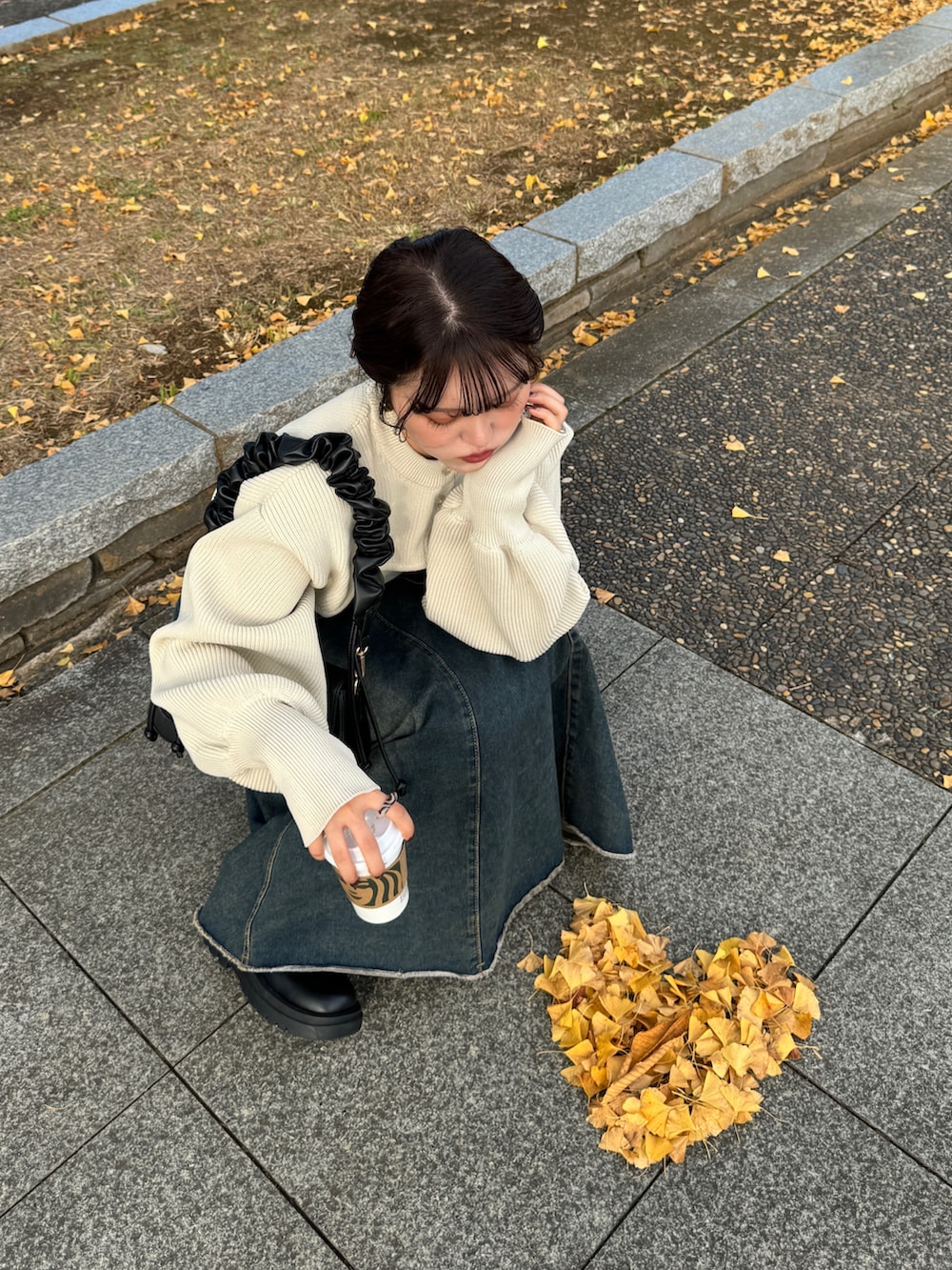 ブラウン系のハンドバッグ、ホワイト系のカーディガン/ボレロを着用したレディースの秋コーディネートの5枚目の写真