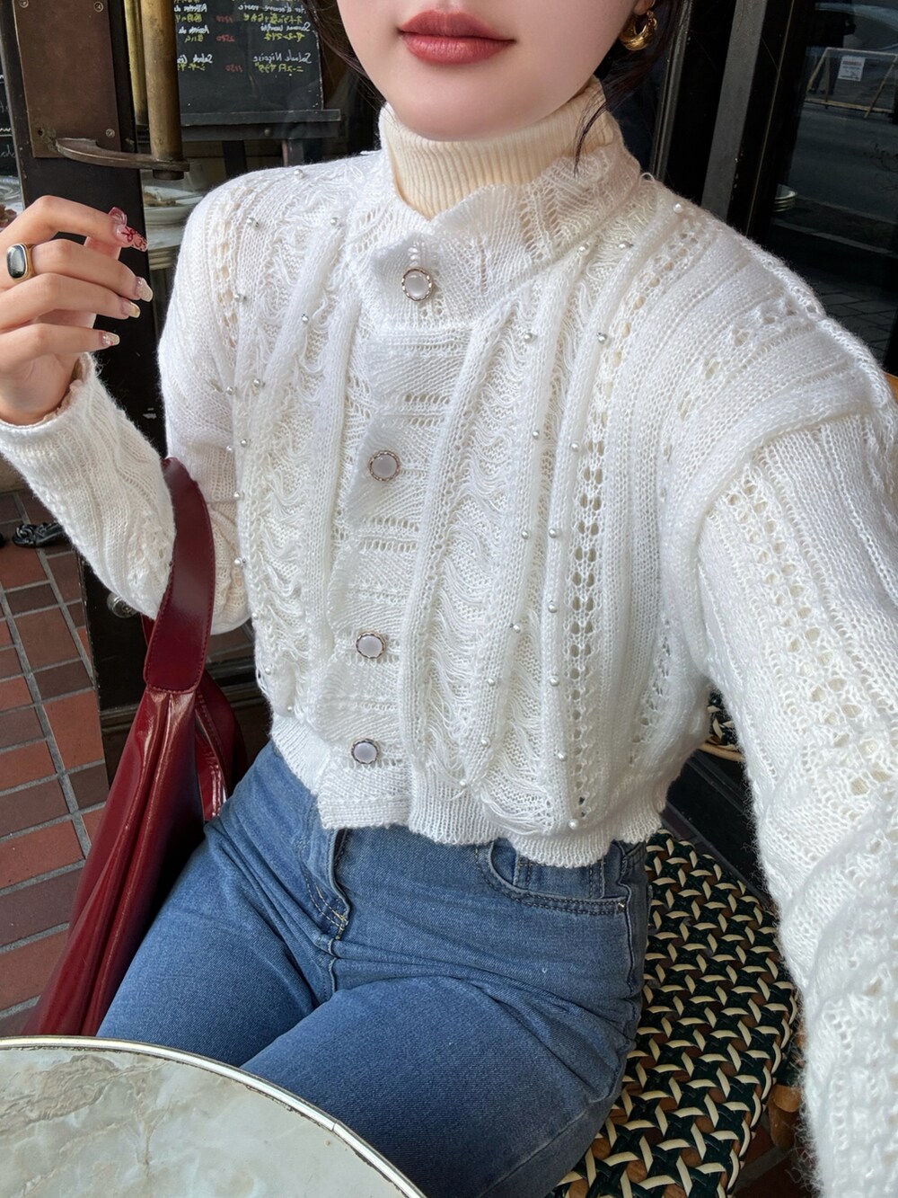 ホワイト系のカーディガン/ボレロ、レッド系のショルダーバッグを着用したレディースの春コーディネートの4枚目の写真