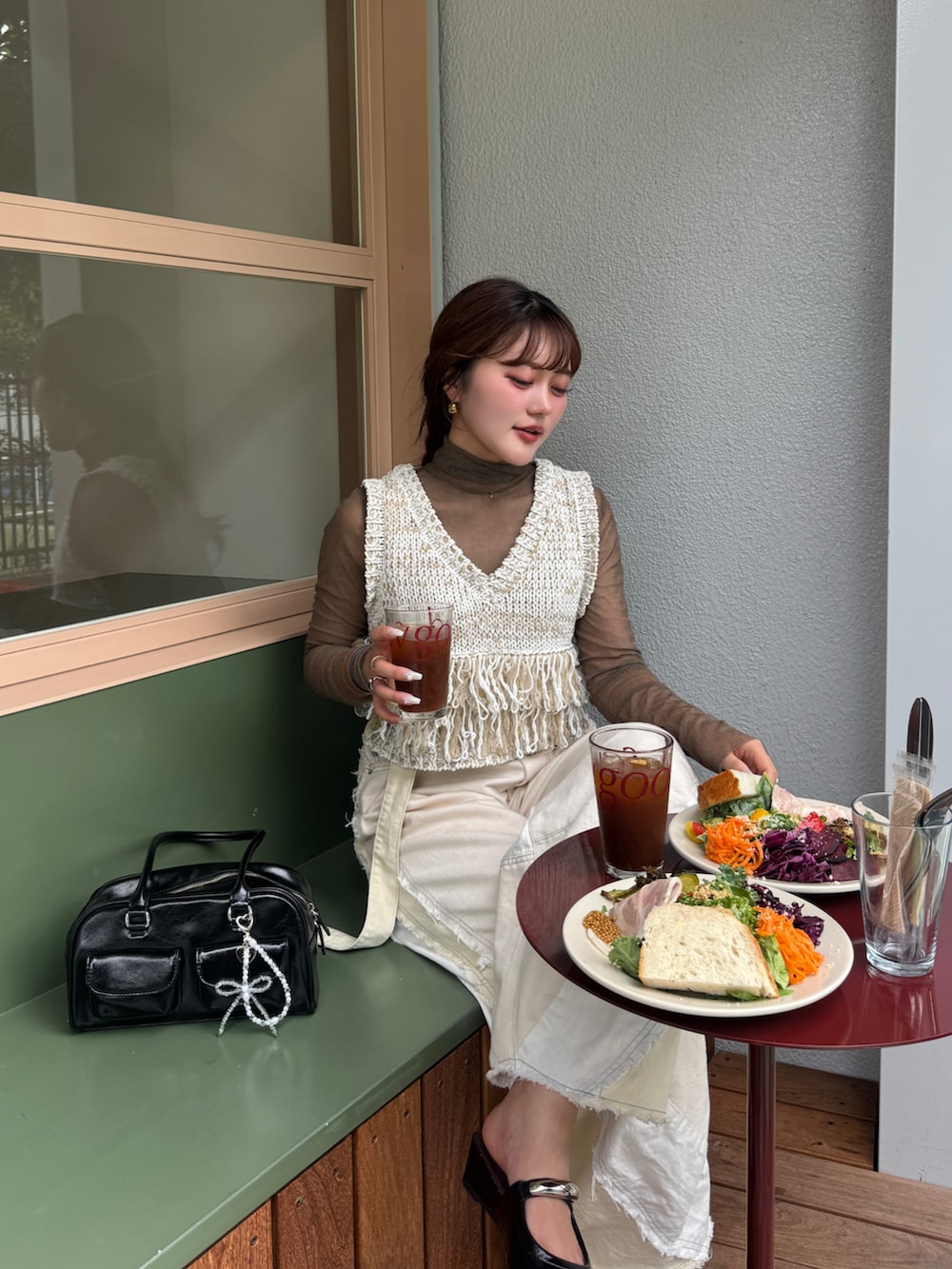 ブラック系のパンプス、ホワイト系のデニムパンツ、ホワイト系のベストを着用したレディースの夏コーディネートの3枚目の写真