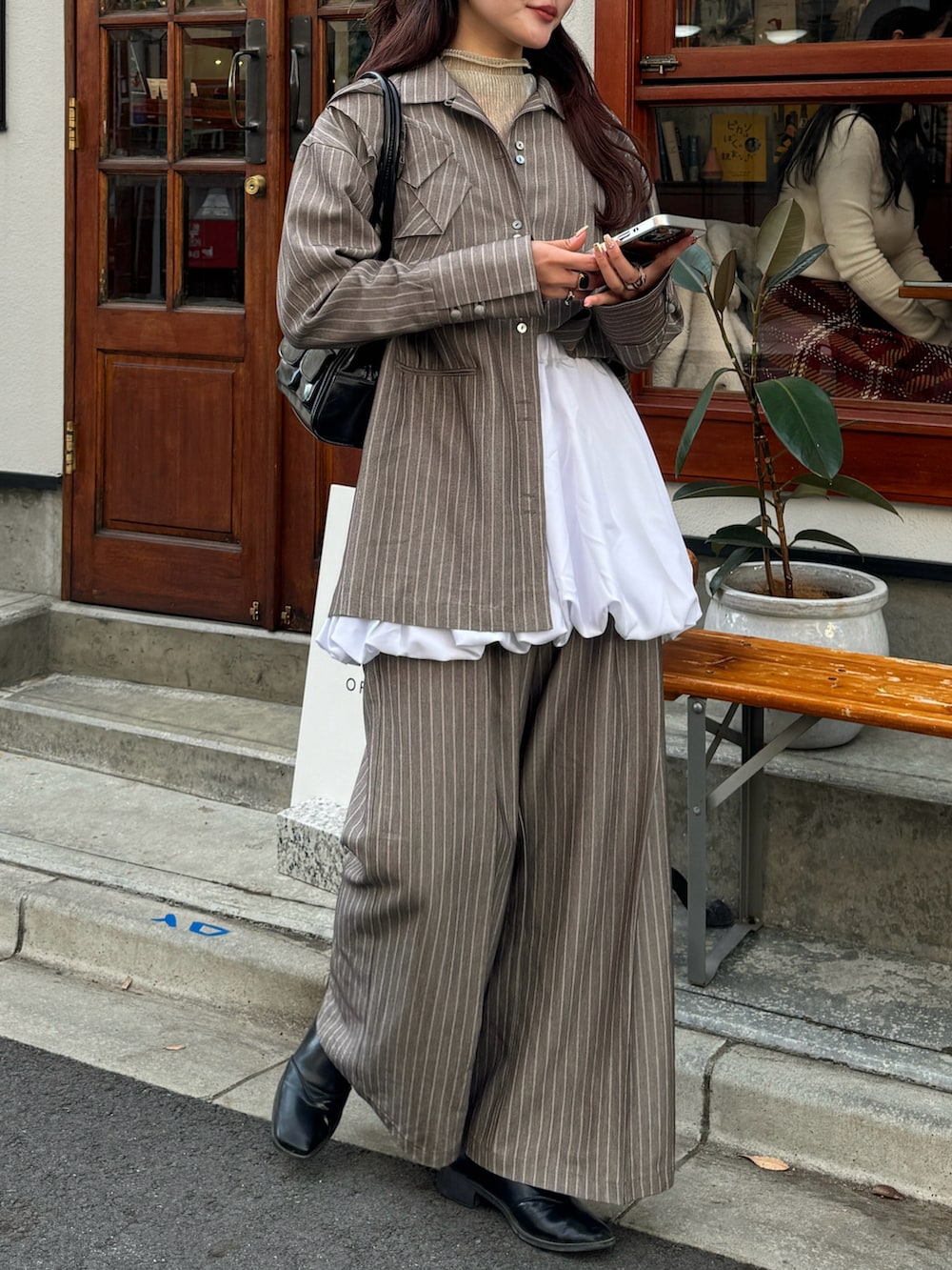 ブラウン系のシャツ/ブラウス、ブラウン系のその他パンツ、ホワイト系のスカートを着用したレディースの冬コーディネートの4枚目の写真