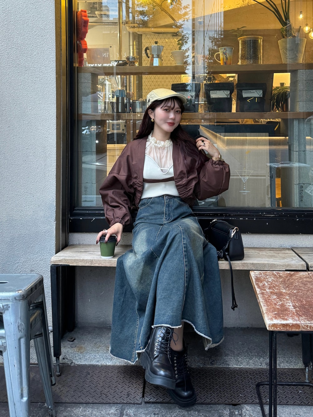 ブラウン系のハンドバッグ、ブラウン系のブルゾンを着用したレディースの秋コーディネートの5枚目の写真