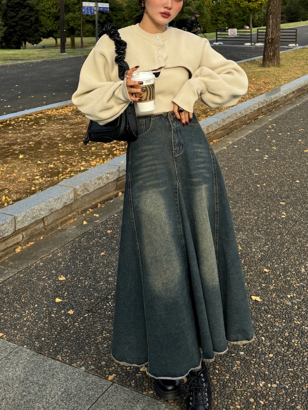 ブラウン系のハンドバッグ、ホワイト系のカーディガン/ボレロを着用したレディースの秋コーディネートの2枚目の写真