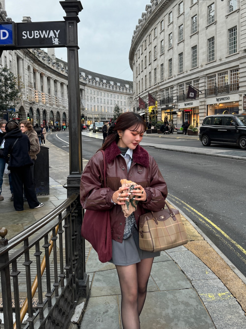 レッド系のその他アウター、グレー系のスカート、グレー系のベストを着用したレディースの冬コーディネートの3枚目の写真