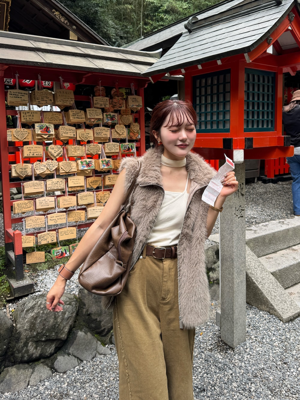 ホワイト系のキャミソール、ブラウン系のボストンバッグを着用したレディースの秋コーディネートの2枚目の写真