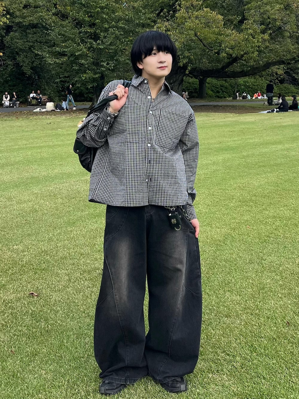 ブラック系のデニムパンツ、ブラック系のシャツ/ブラウス、ブラック系のショルダーバッグを着用したメンズの秋コーディネートの2枚目の写真