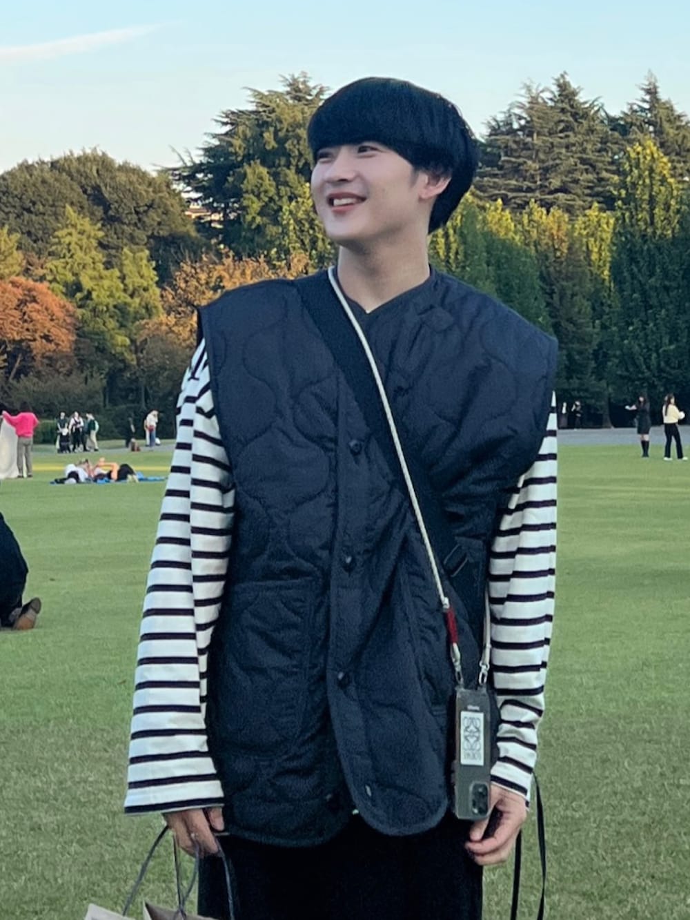 ブラック系のスラックス、ブラック系のミリタリージャケット、ホワイト系のTシャツ/カットソーを着用したメンズの秋コーディネートの2枚目の写真