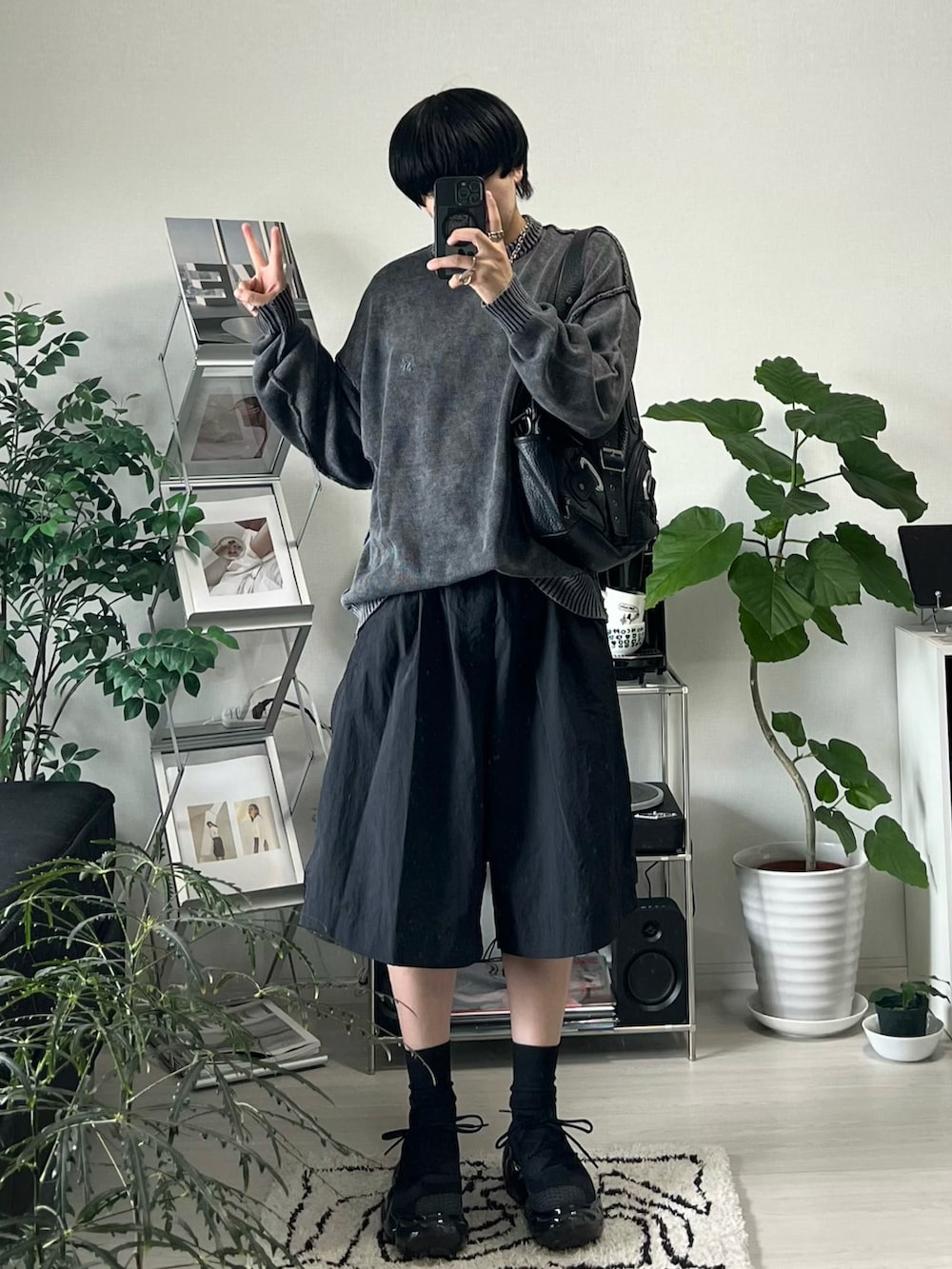 ブラック系のニット/セーター、ブラック系のパンツ、ブラック系のスニーカーを着用したメンズの夏コーディネートの3枚目の写真