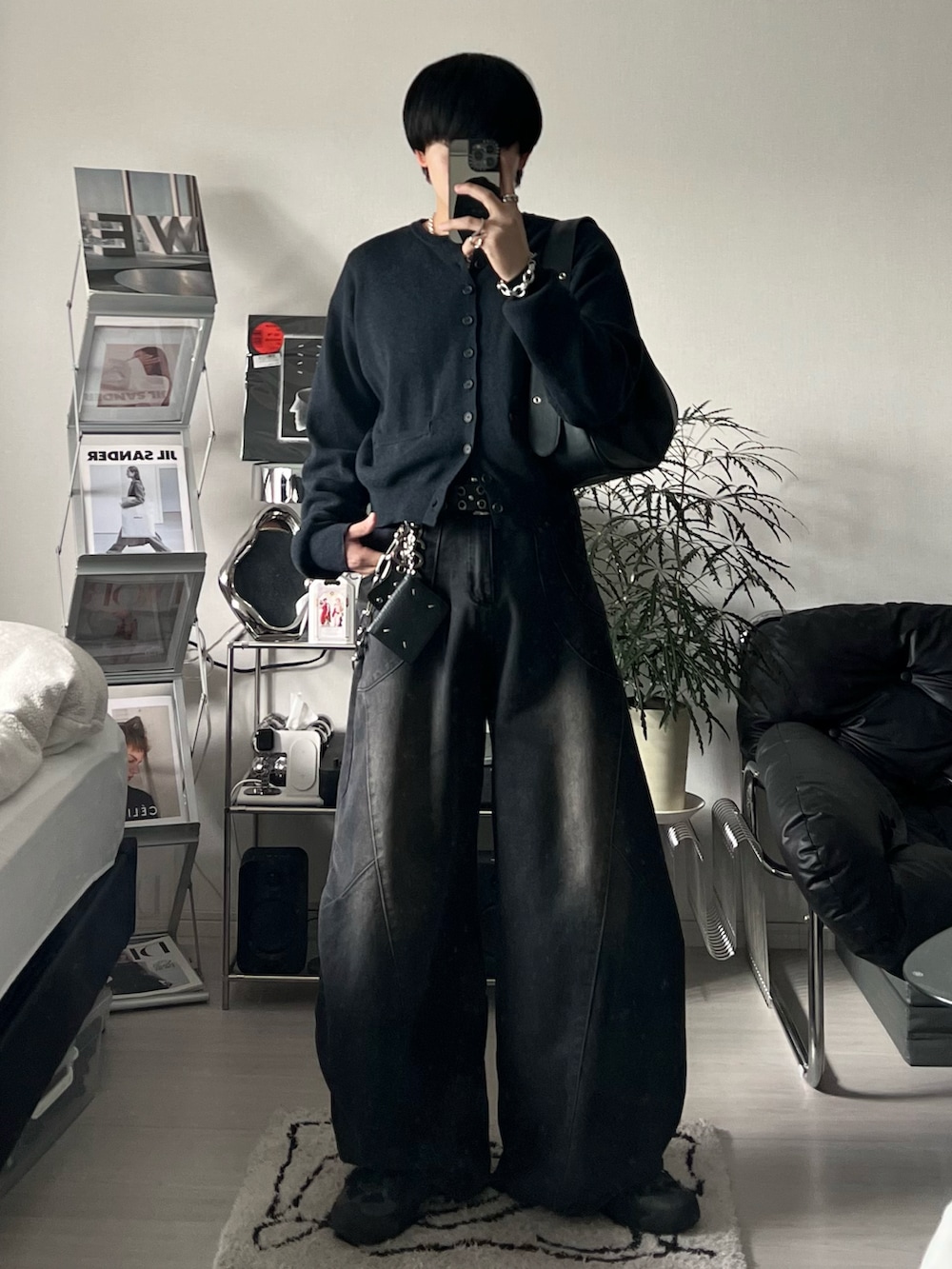 ブラック系のカーディガン/ボレロ、ブラック系のデニムパンツ、ブラック系のスニーカーを着用したメンズの冬コーディネートの2枚目の写真