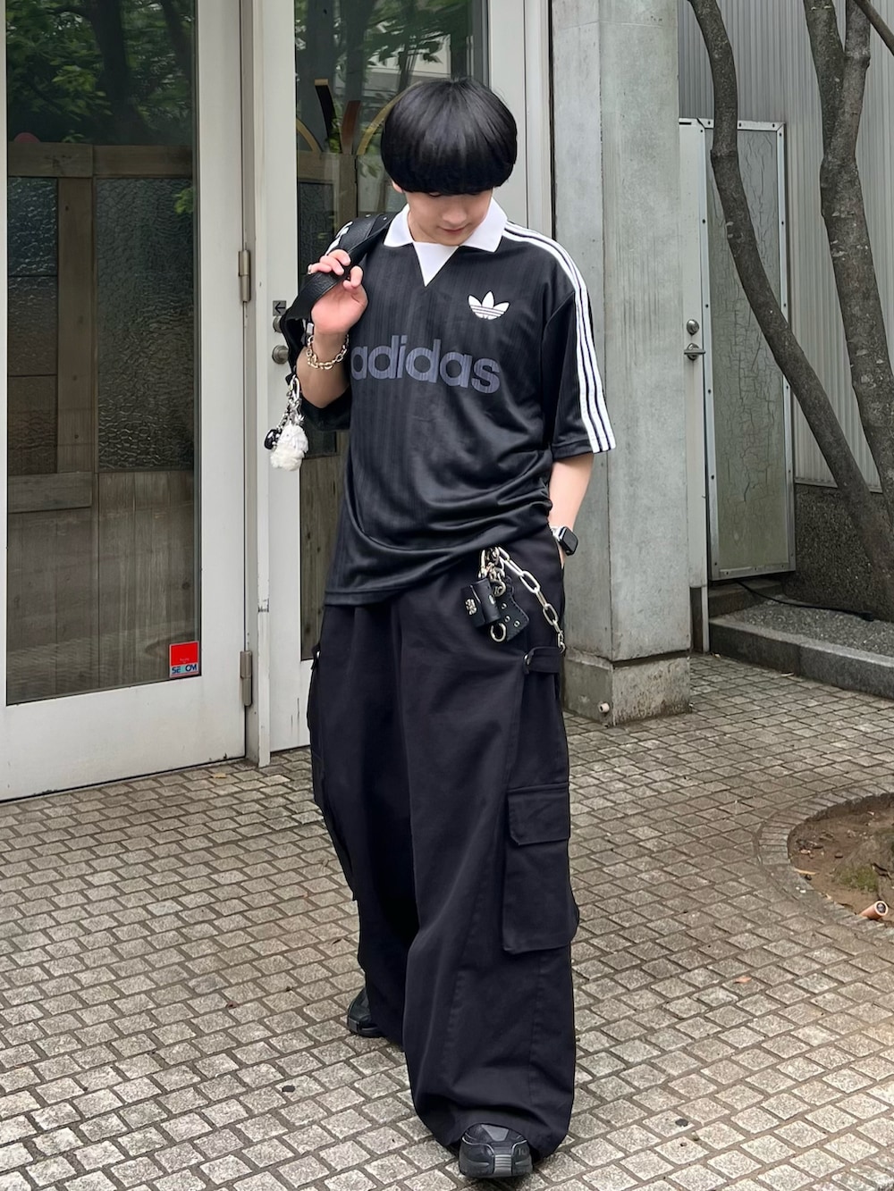 ブラック系のTシャツ/カットソー、ブラック系のショルダーバッグ、ブラック系のカーゴパンツを着用したメンズの夏コーディネートの3枚目の写真