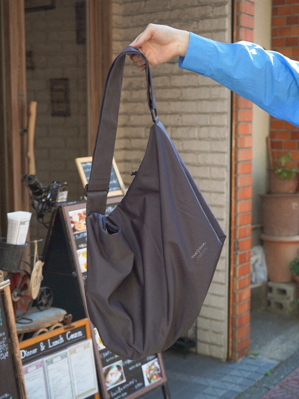 ブラック系のベスト、ブルー系のシャツ/ブラウス、ブラック系のデニムパンツを着用したメンズの春コーディネートの4枚目の写真