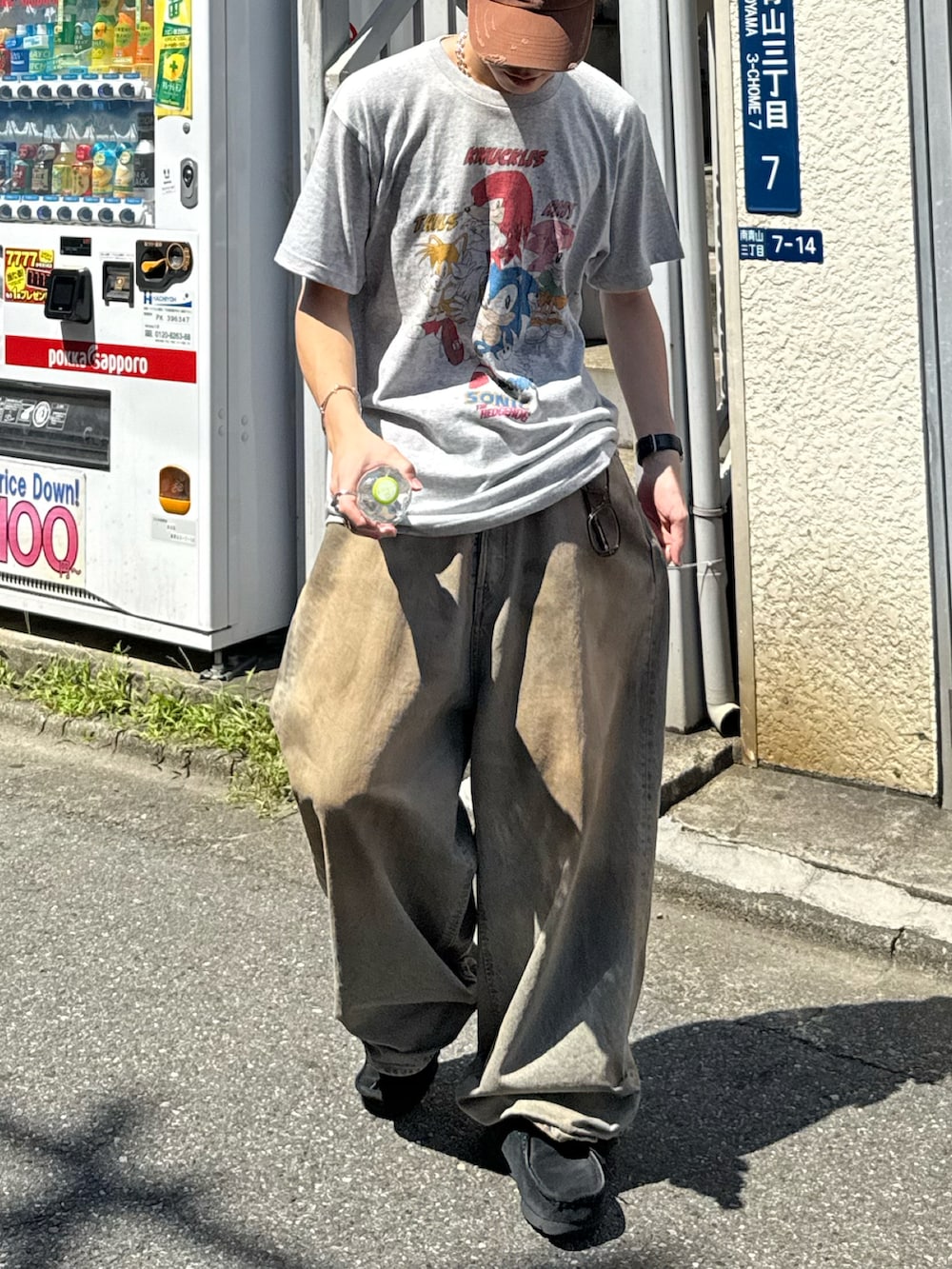 グレー系のTシャツ/カットソー、ブルー系のデニムパンツ、ブラック系のモカシン/デッキシューズを着用したメンズの夏コーディネートの3枚目の写真