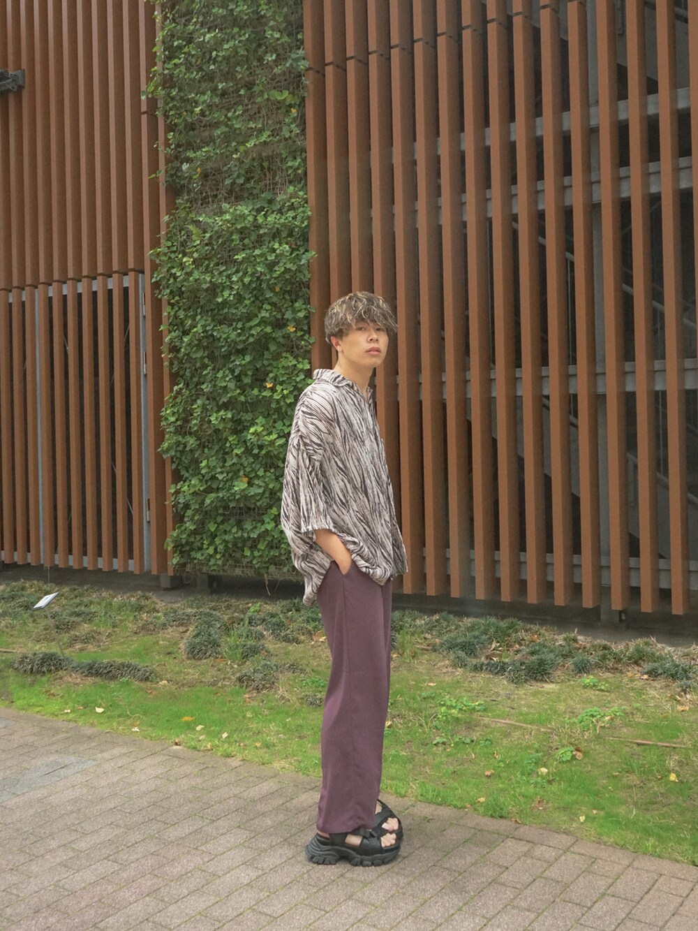 ベージュ系のシャツ/ブラウス、レッド系のスラックス、ブラック系のサンダルを着用したメンズの夏コーディネートの3枚目の写真