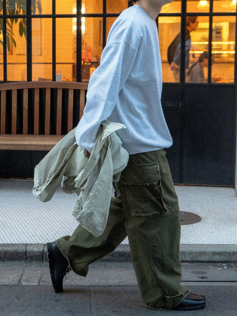 グレー系のスウェット、グリーン系のカーゴパンツ、ベージュ系のマウンテンパーカーを着用したメンズの秋コーディネートの5枚目の写真