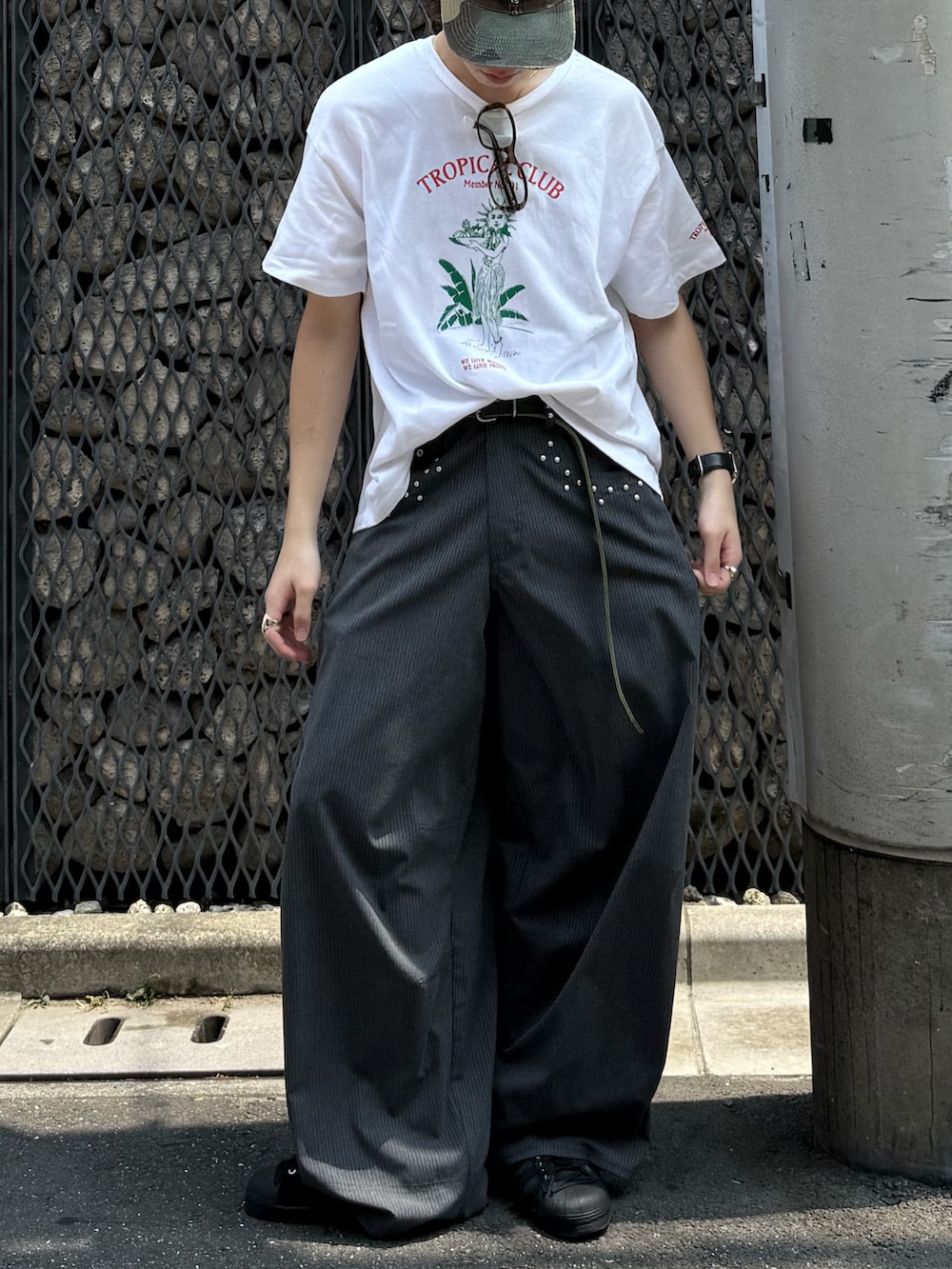 ホワイト系のTシャツ/カットソー、グレー系のスラックス、ブラック系のスニーカーを着用したメンズの夏コーディネートの4枚目の写真