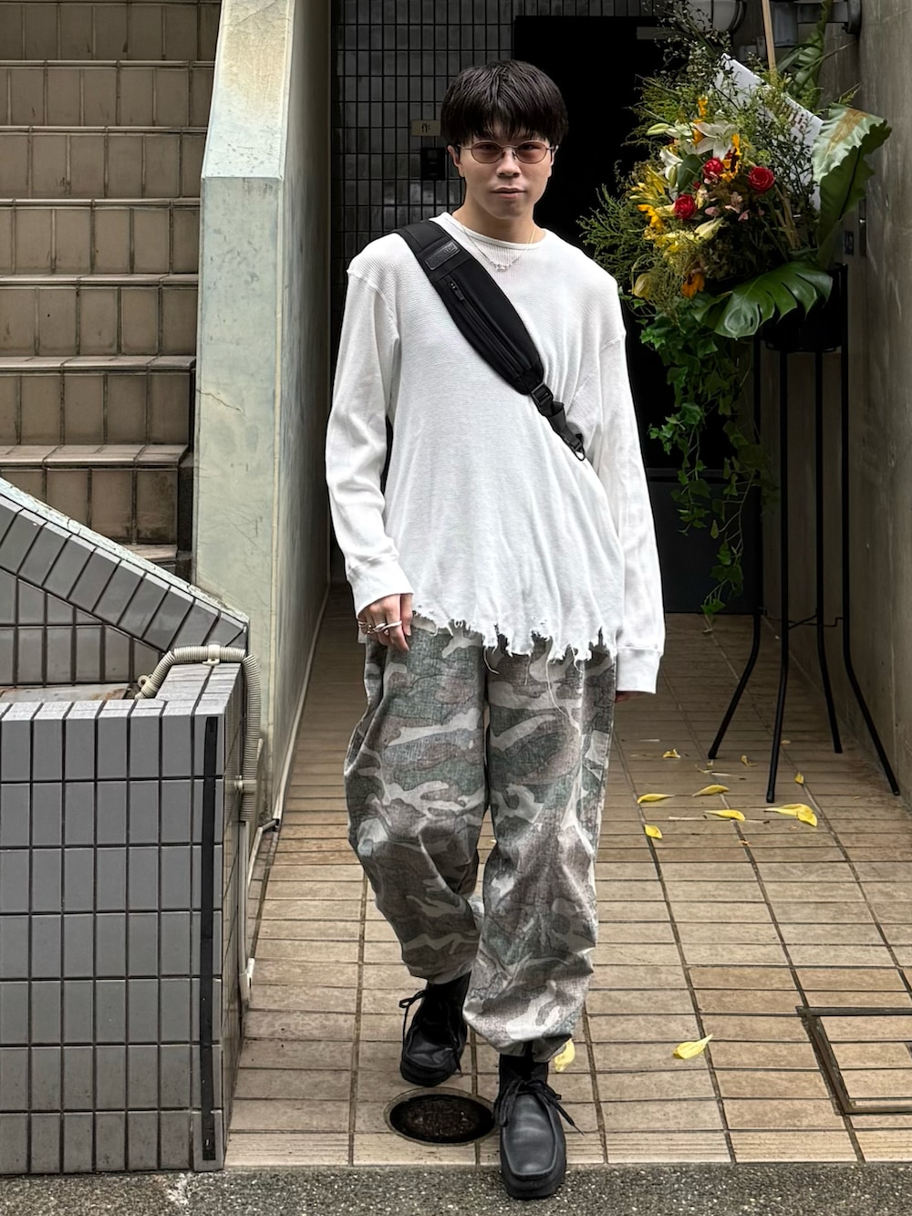 ホワイト系のTシャツ/カットソー、ブラック系のショルダーバッグ、ブラック系のブーツを着用したメンズの秋コーディネートの3枚目の写真