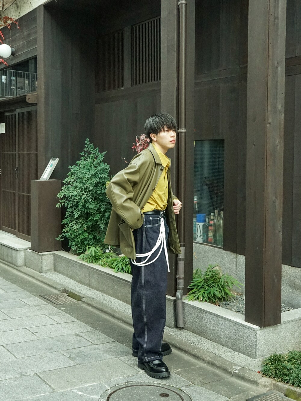 グリーン系のカバーオール、イエロー系のシャツ/ブラウス、ブルー系のデニムパンツを着用したメンズの冬コーディネートの3枚目の写真