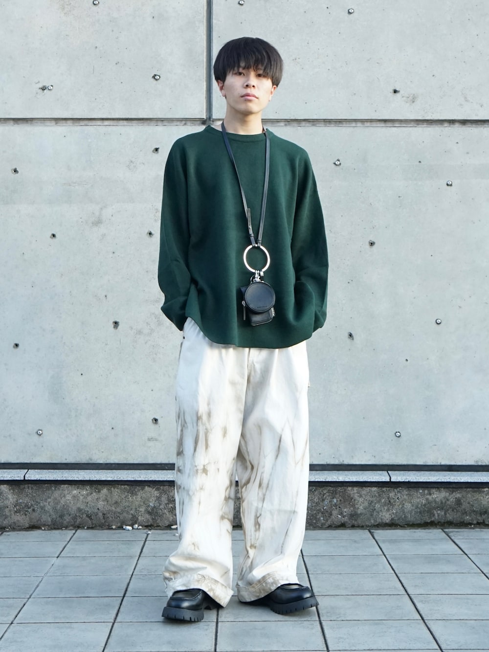 グリーン系のニット/セーター、ベージュ系のその他パンツ、ブラック系のショルダーバッグを着用したメンズの秋コーディネートの2枚目の写真