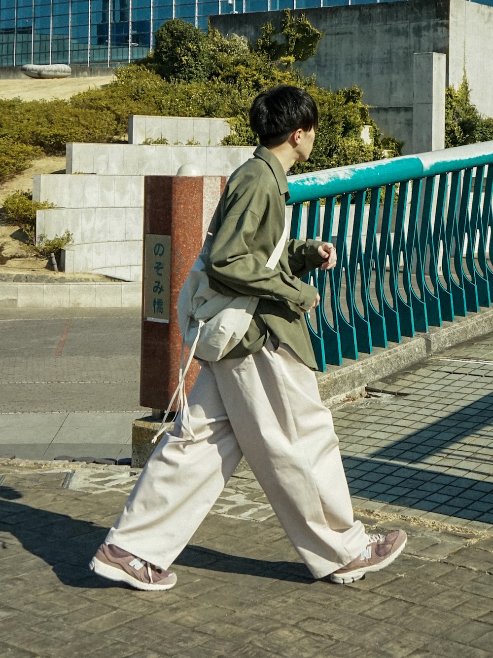 グリーン系のシャツ/ブラウス、ベージュ系のその他パンツ、ブラウン系のスニーカーを着用したメンズの春コーディネートの2枚目の写真