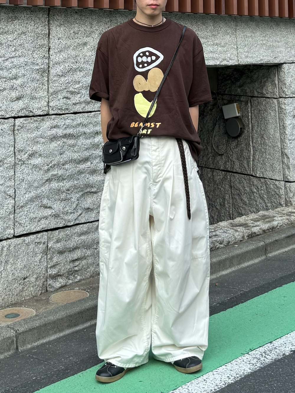 ブラウン系のTシャツ/カットソー、ホワイト系のその他パンツ、ブラック系のスニーカーを着用したメンズの夏コーディネートの2枚目の写真