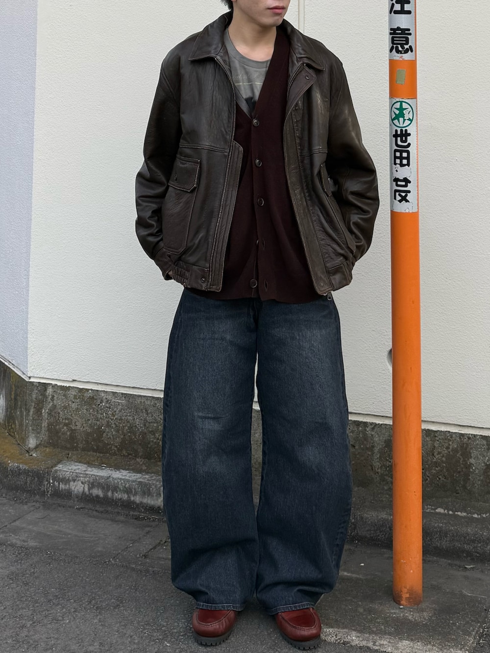 ホワイト系のTシャツ/カットソー、ブラウン系のブルゾン、ブルー系のデニムパンツを着用したメンズの冬コーディネートの5枚目の写真