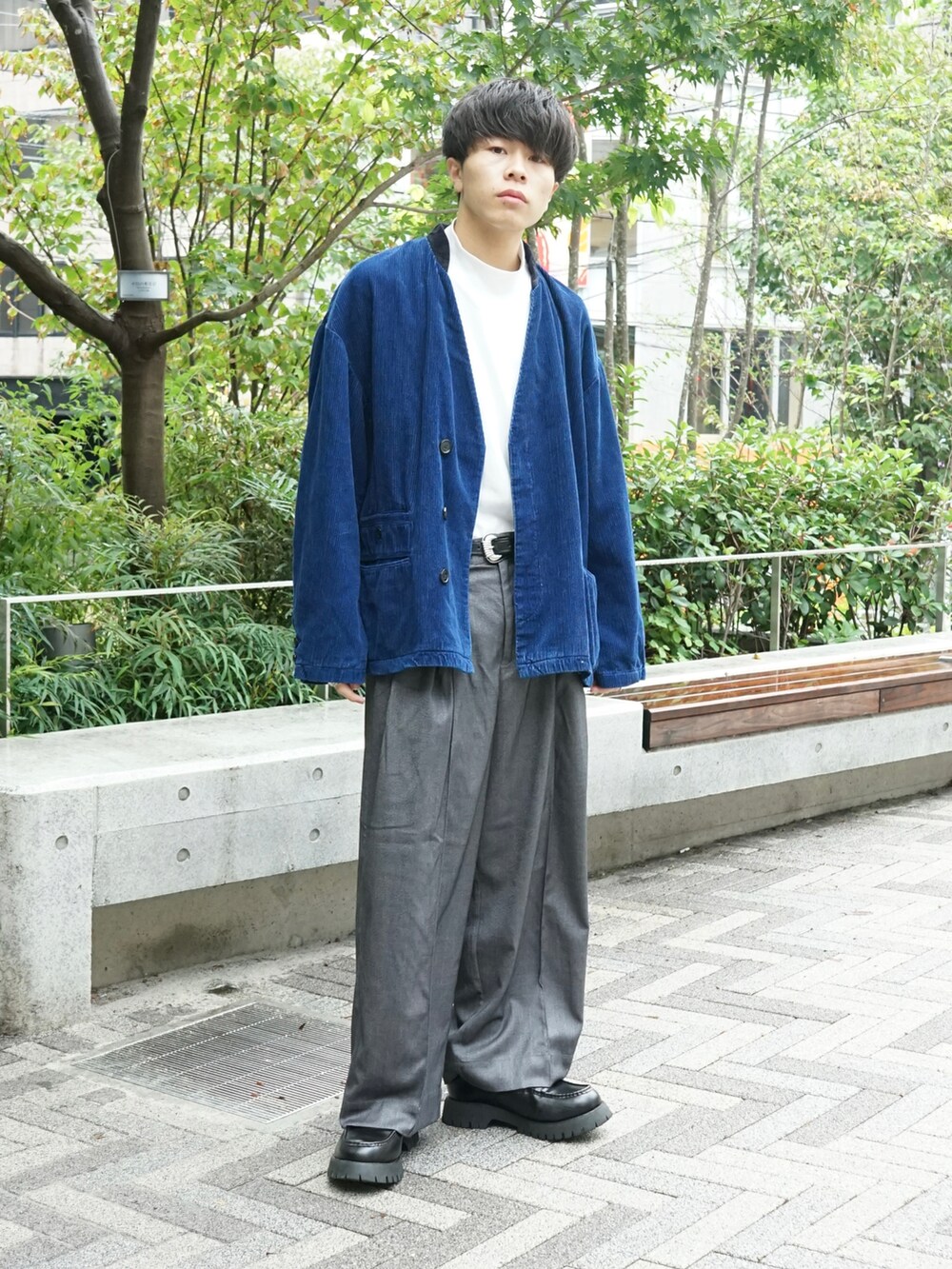 ブルー系のテーラードジャケット、グレー系のスラックス、ブラック系のローファーを着用したメンズの秋コーディネートの3枚目の写真