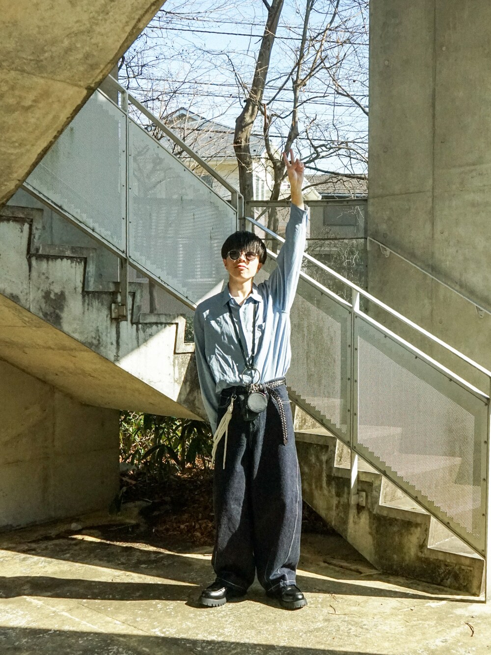 ブルー系のシャツ/ブラウス、ブルー系のデニムパンツ、ブラック系のショルダーバッグを着用したメンズの春コーディネートの3枚目の写真