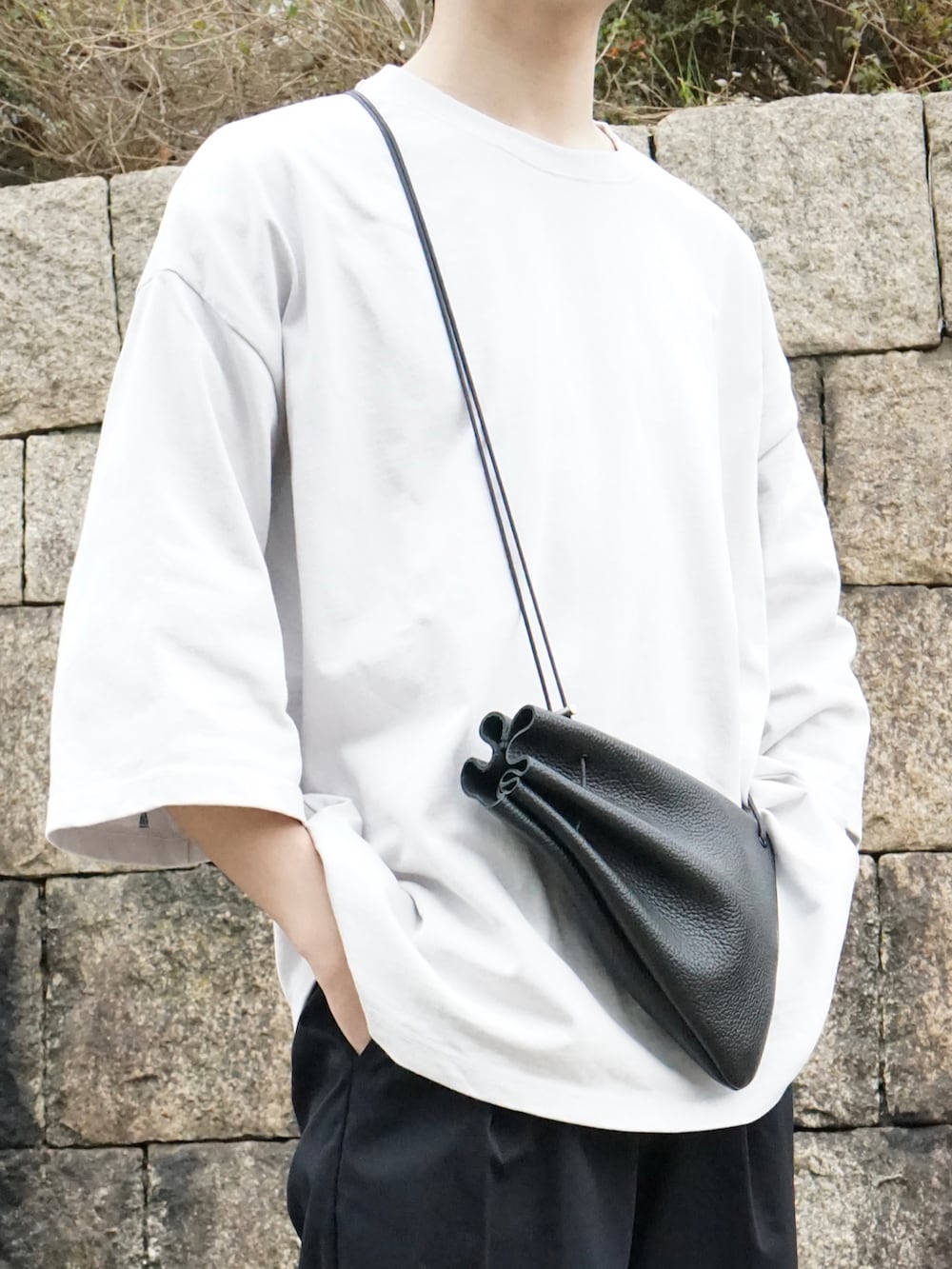 グレー系のTシャツ/カットソー、ブラック系のその他パンツ、ブラック系のショルダーバッグを着用したメンズの春コーディネートの4枚目の写真