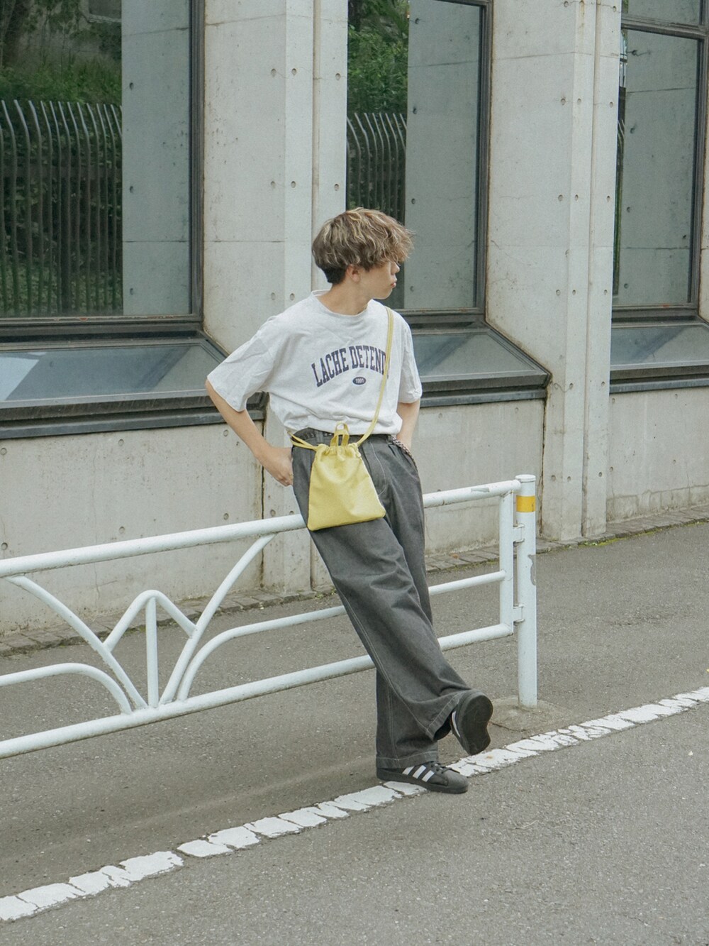 グレー系のTシャツ/カットソー、グレー系のデニムパンツ、イエロー系のショルダーバッグを着用したメンズの夏コーディネートの3枚目の写真