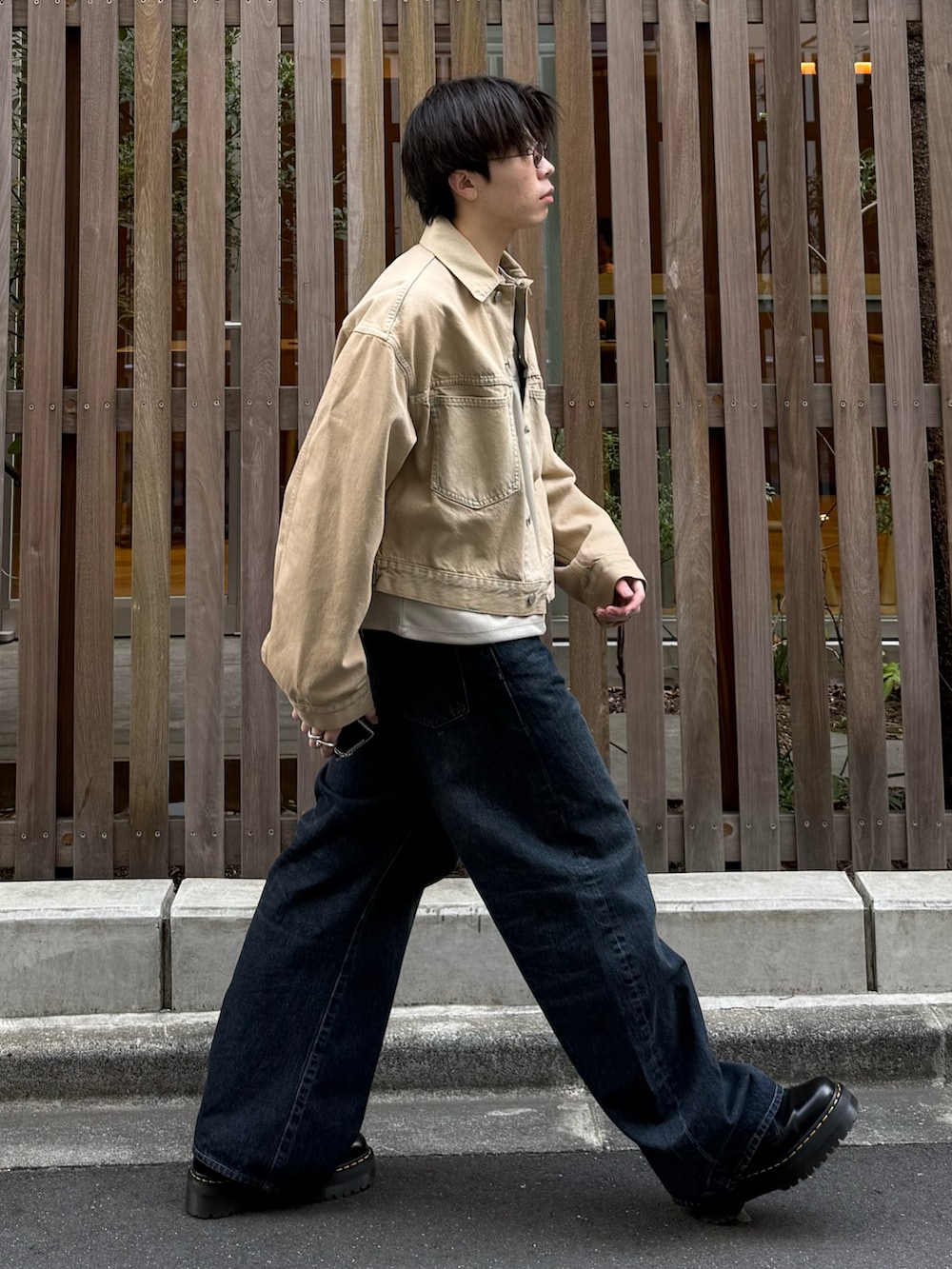 ベージュ系のTシャツ/カットソー、ブルー系のデニムパンツ、ブラック系のブーツを着用したメンズの春コーディネートの2枚目の写真