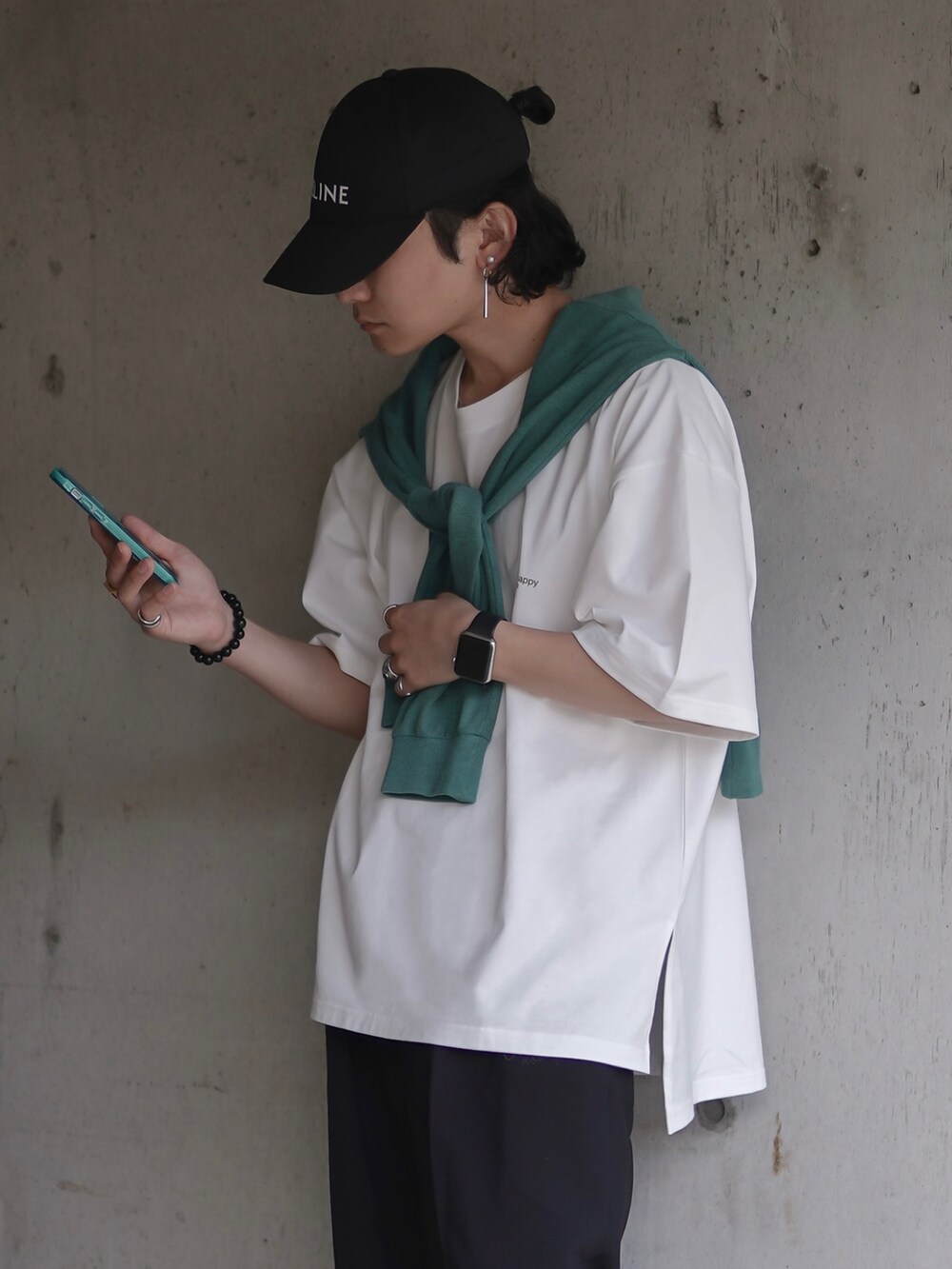 グリーン系のシューズ、ブラック系のスラックス、ホワイト系のTシャツ/カットソーを着用したメンズの夏コーディネートの2枚目の写真