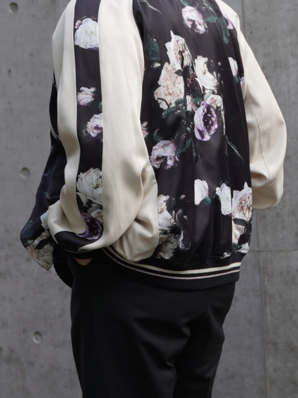 ブラック系のスラックス、ブラック系のシューズ、ブルー系のブルゾンを着用したメンズの春コーディネートの3枚目の写真