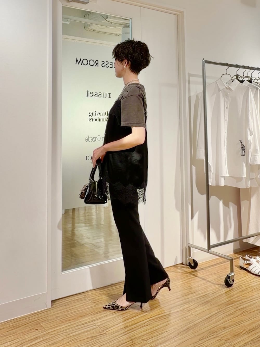 グレー系のTシャツ/カットソー、ブラック系のキャミソール、ブラック系のスラックスを着用したレディースの春コーディネートの5枚目の写真