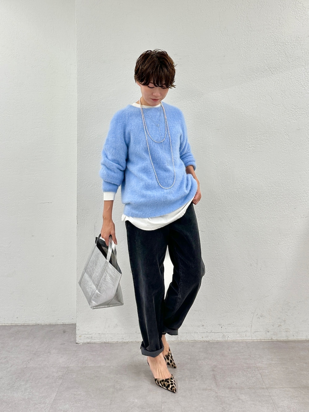 ホワイト系のTシャツ/カットソー、ベージュ系のニット/セーター、シルバー系のトートバッグを着用したレディースの秋コーディネートの6枚目の写真