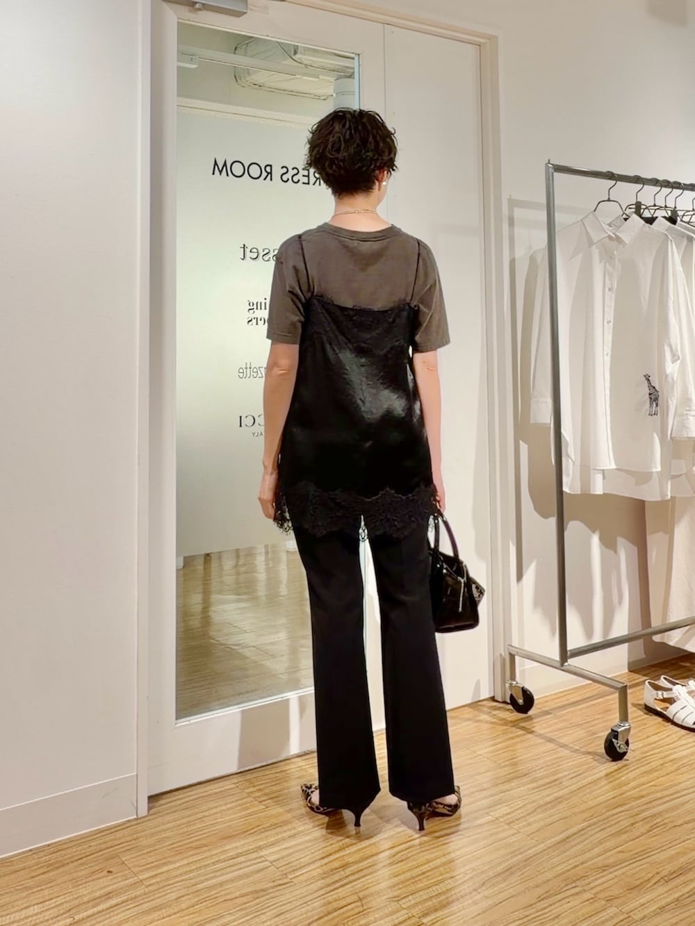 グレー系のTシャツ/カットソー、ブラック系のキャミソール、ブラック系のスラックスを着用したレディースの春コーディネートの4枚目の写真